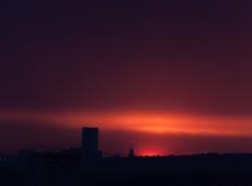 The third stage of the industrial sunset above the Silesian coal mine Bielszowice ( KWK Bielszowice ) in Ruda Śląska. Photo was taken from Katowice, about 15 kilometers away.